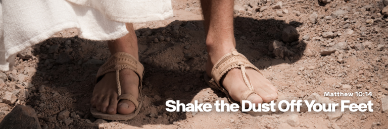 Close-up of two people wearing sandals walking on a dry, dusty path with the title Shake the Dust Off Your Feet displayed at the bottom.
