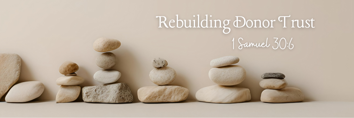 Stacked stones arranged in balanced formations on a neutral background, symbolizing stability, restoration, and rebuilding donor trust, with the title Rebuilding Donor Trust displayed above the image