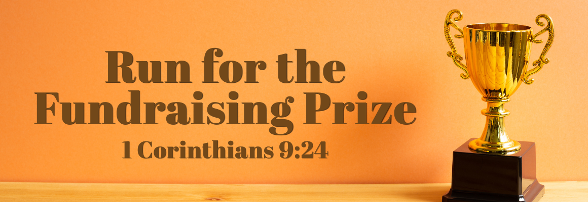 A gold trophy on a wooden surface against an orange background, with the text “Run for the Fundraising Prize” and “1 Corinthians 9:24” displayed beside it.