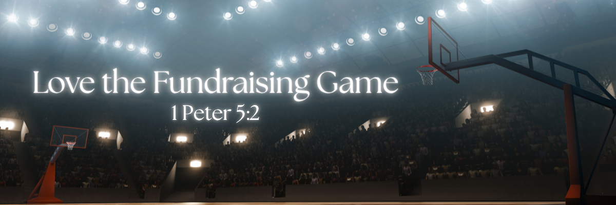 A dramatic wide-angle view of a packed basketball arena with bright overhead lights and two visible hoops, with the text Love the Fundraising Game and the scripture reference 1 Peter 5:2 in white lettering.