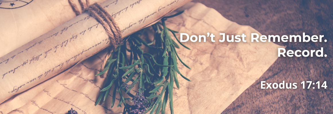 Scroll tied with twine beside rosemary and lavender, with text 'Don't Just Remember. Record. Exodus 17:14'