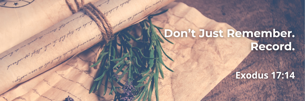 Scroll tied with twine beside rosemary and lavender, with text 'Don't Just Remember. Record. Exodus 17:14'